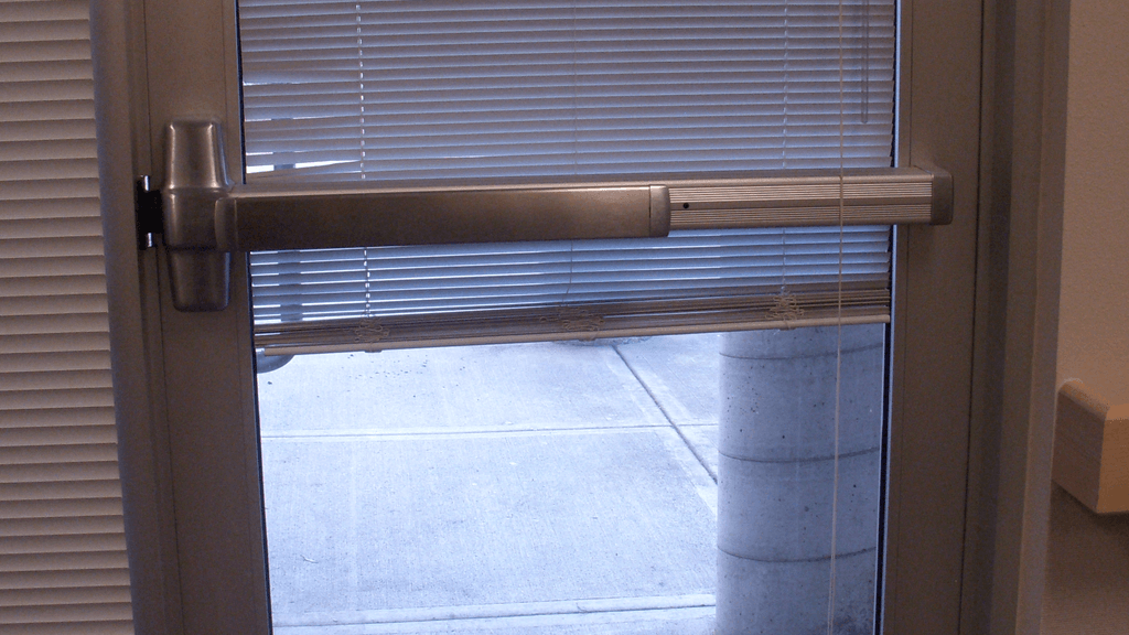 Real commercial exit door fitted with a horizontal panic bar