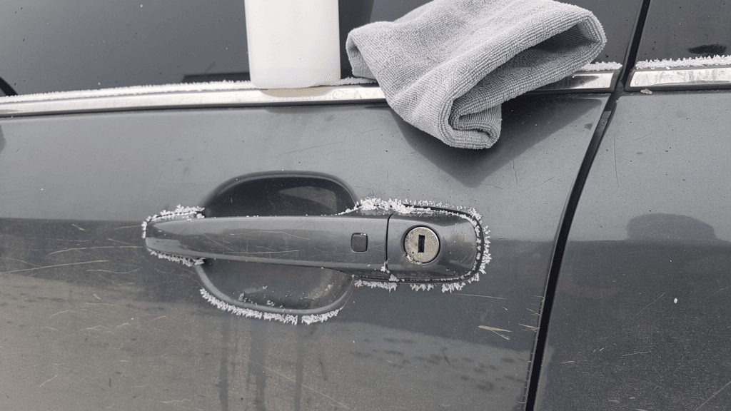Frosted car door handle with automotive deicer and a soft cloth