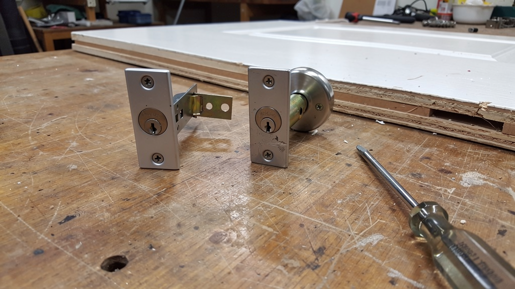 Unbranded smart-lock components and tools on a locksmith workbench