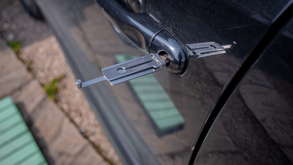 Real vehicle door handle with keys resting beside it