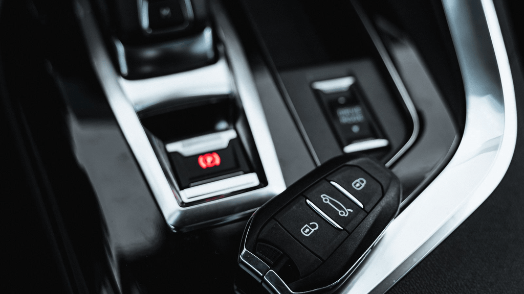 Real vehicle key fob beside a car center console